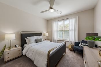 Primary bedroom at the tribute apartments in raleigh, nc 27612